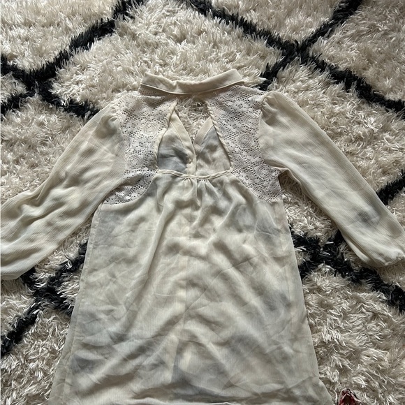 From Vanity it’s a cream colored dressy button down shirt and is a size M - Picture 2 of 3